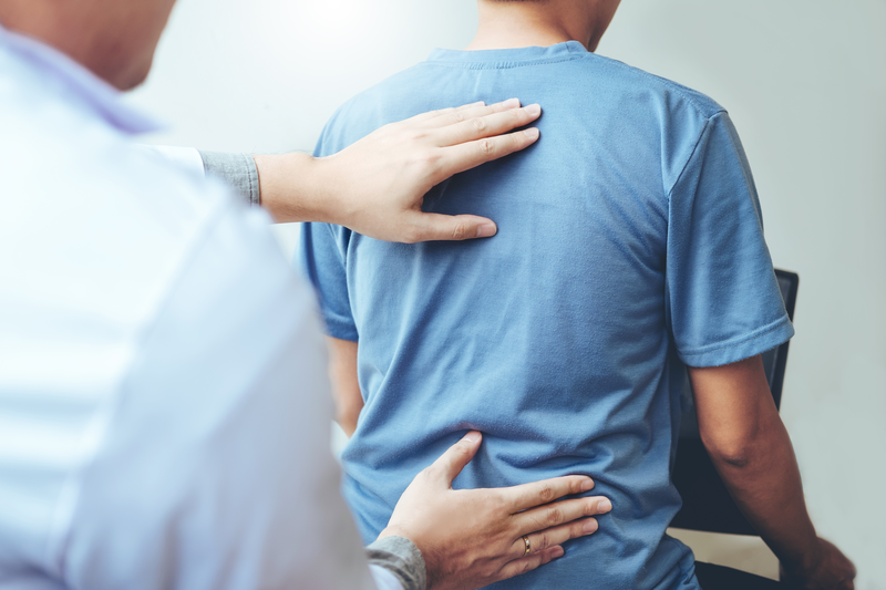 chiropractor adjusting patient's back