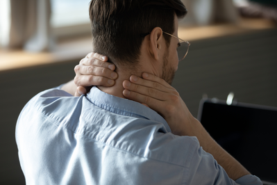 man holding neck