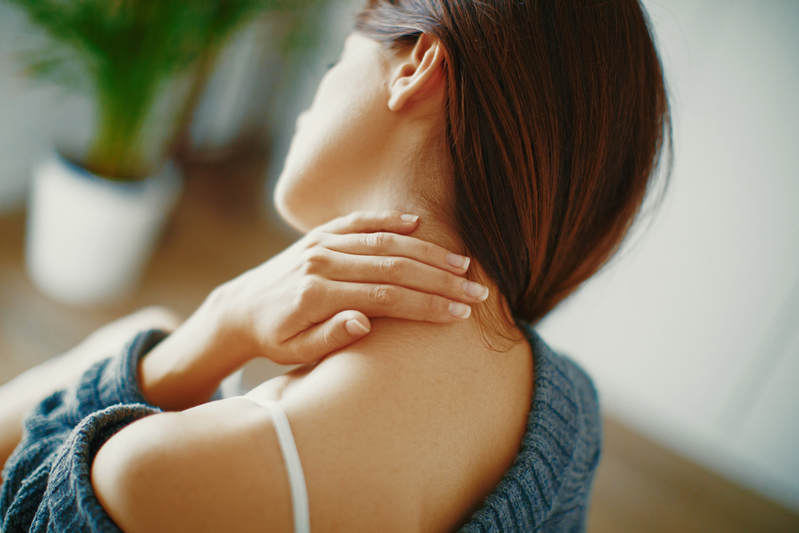 woman holding neck