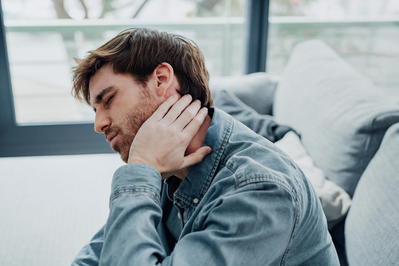 man holding side of neck